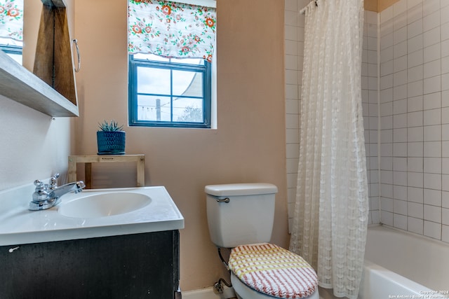 full bathroom featuring toilet, vanity, and shower / tub combo with curtain