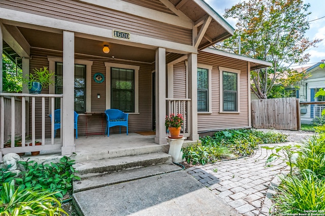 view of exterior entry with a porch