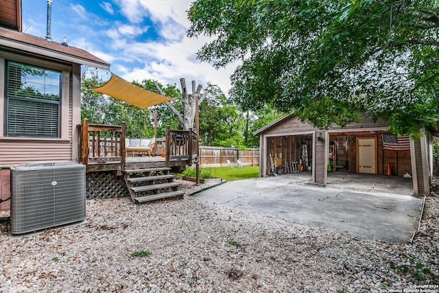 view of yard with a deck and central AC