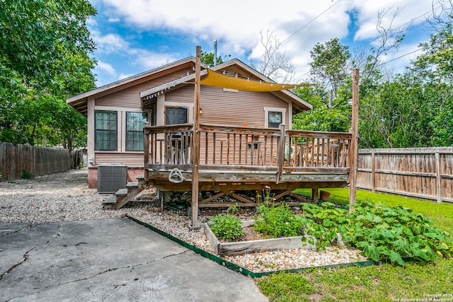 back of property featuring central AC unit and a deck