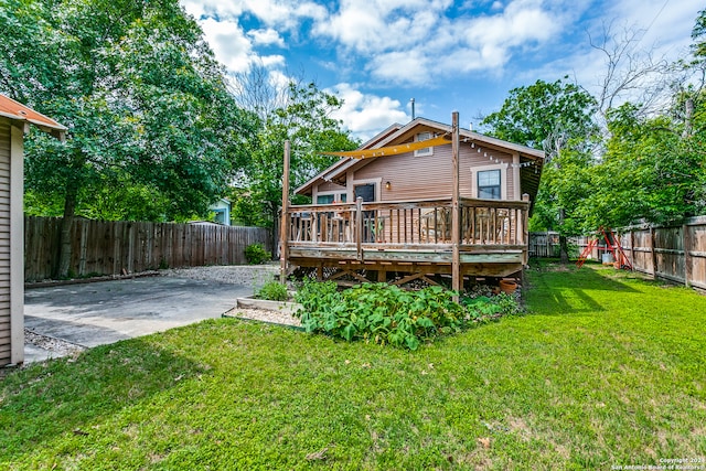 rear view of property with a yard, a patio, and a wooden deck