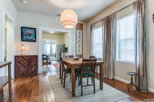 dining space with dark hardwood / wood-style floors