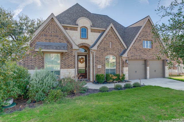 view of front of house with a garage and a front lawn