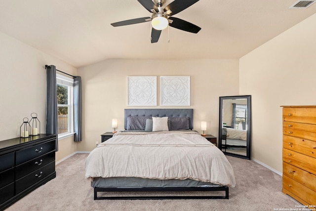 bedroom with ceiling fan, lofted ceiling, and light carpet