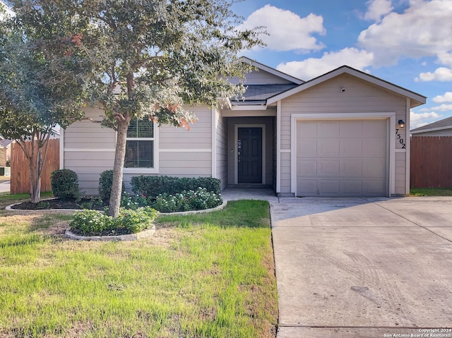 view of front facade with a front yard and a garage