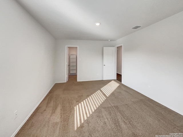 7502 Hercules Pt, San Antonio, TX 78252 - unfurnished bedroom featuring carpet flooring, baseboards, a walk in closet, a closet, and recessed lighting