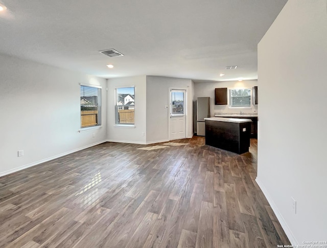 7502 Hercules Pt, San Antonio, TX 78252 - unfurnished living room featuring dark wood-type flooring, baseboards, and recessed lighting
