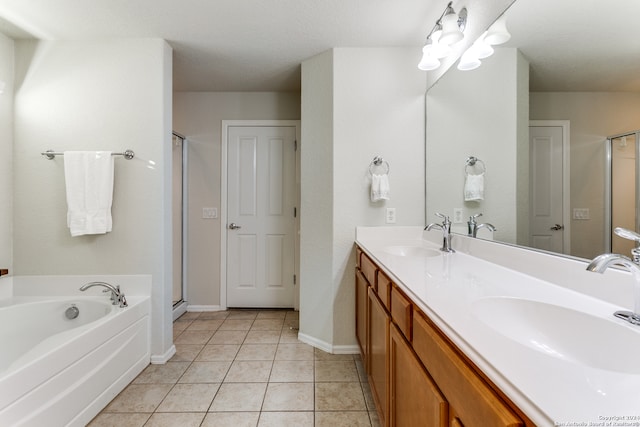 bathroom with tile patterned flooring, vanity, shower with separate bathtub, and a textured ceiling