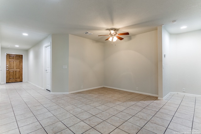 unfurnished room with light tile patterned floors, a textured ceiling, and ceiling fan