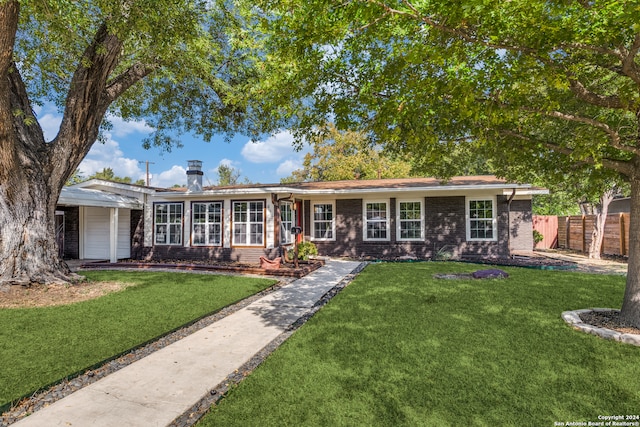 ranch-style home featuring a front yard and a garage