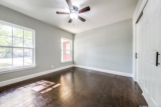 unfurnished bedroom featuring dark hardwood / wood-style flooring, a closet, and ceiling fan