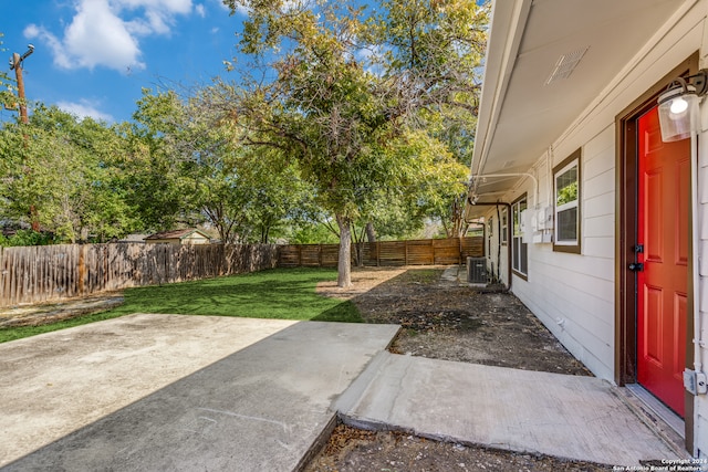 view of yard featuring a patio area and central air condition unit