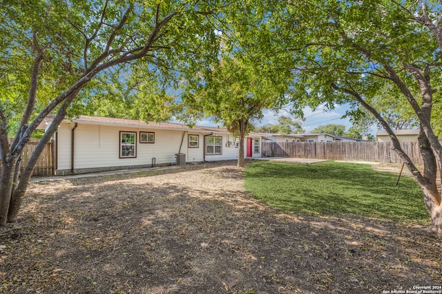 view of front of home featuring a front yard and central AC