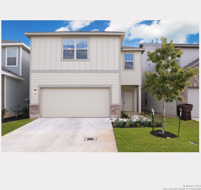 view of front of house with a garage and a front lawn