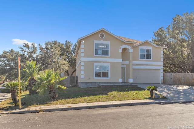 view of front property with a front lawn and a garage