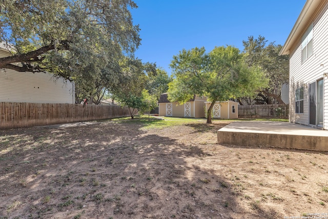 view of yard featuring a patio area and an outbuilding