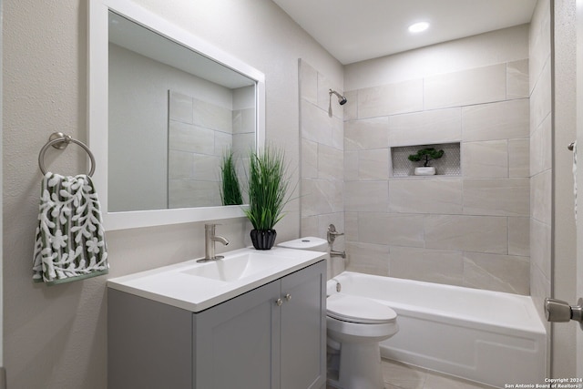 full bathroom featuring toilet, vanity, and tiled shower / bath