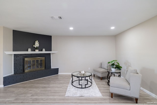 sitting room featuring a fireplace and light hardwood / wood-style floors