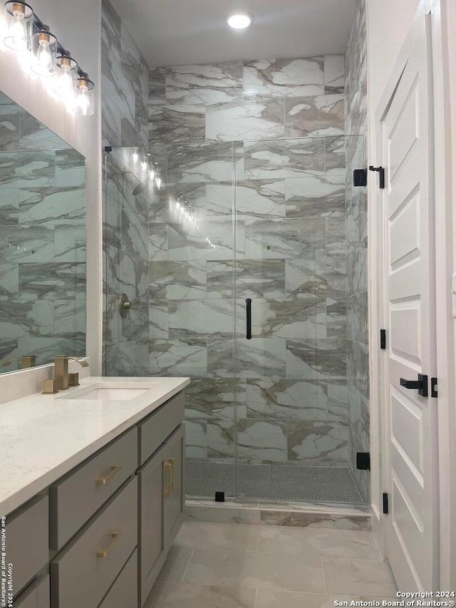 bathroom featuring vanity, an enclosed shower, and tile walls