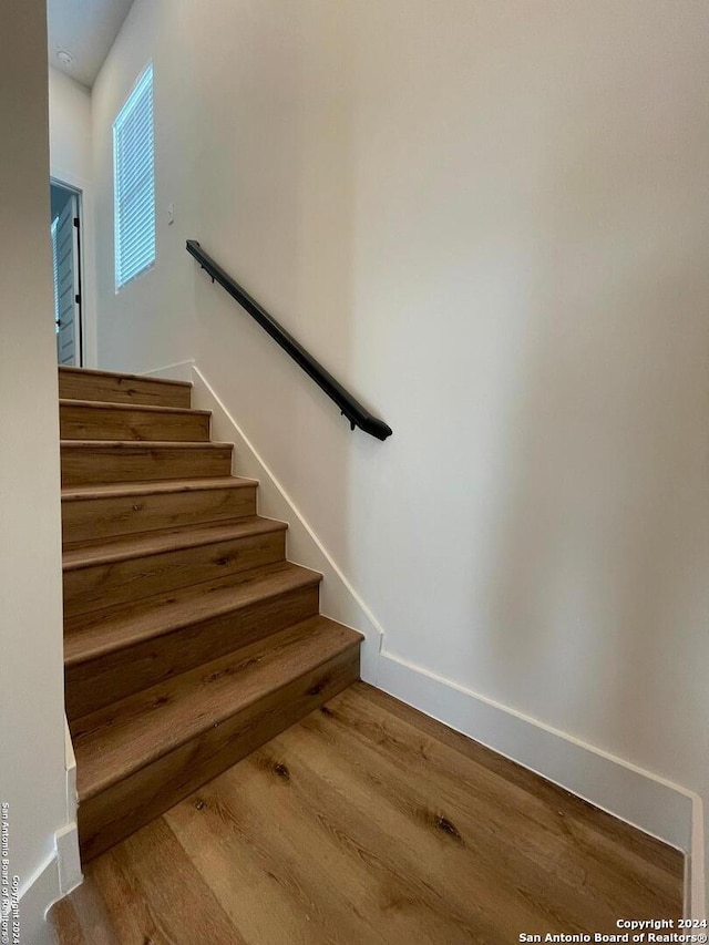 stairs with hardwood / wood-style flooring