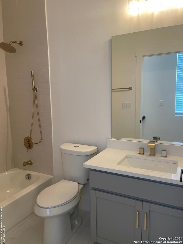 full bathroom featuring tile patterned floors, toilet, vanity, and tiled shower / bath