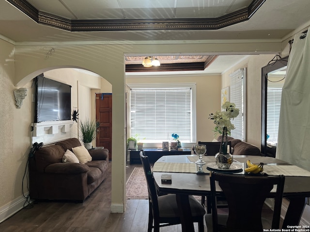 dining room featuring a tray ceiling, crown molding, and hardwood / wood-style floors