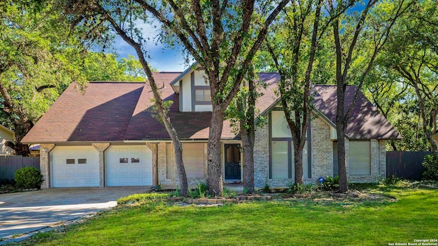 view of front of home with a garage and a front lawn