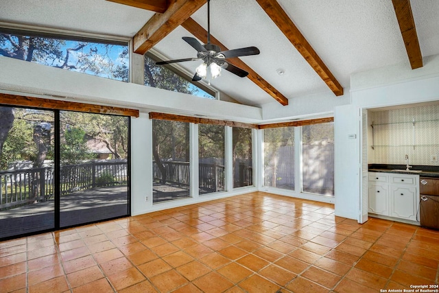 unfurnished sunroom with vaulted ceiling with beams, ceiling fan, and sink