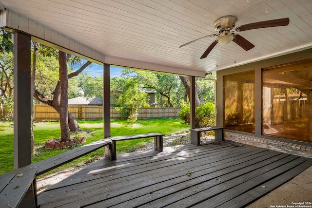 wooden terrace with ceiling fan and a yard