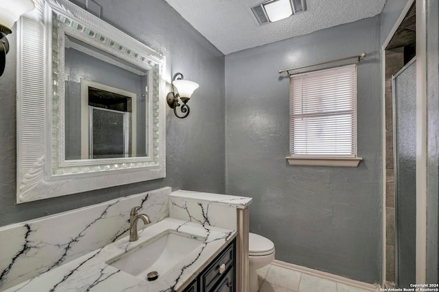 bathroom featuring walk in shower, vanity, a textured ceiling, and toilet