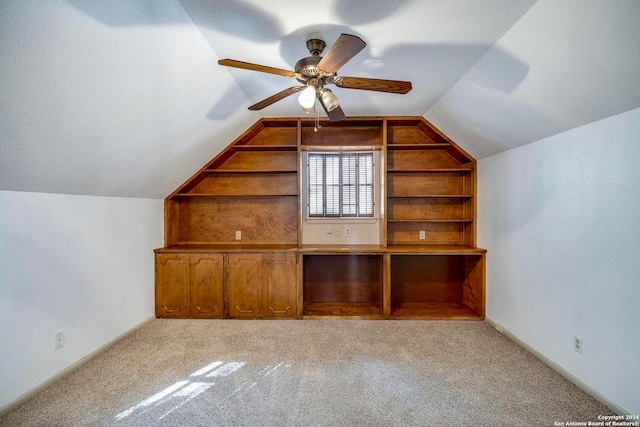 additional living space featuring light carpet, ceiling fan, and lofted ceiling