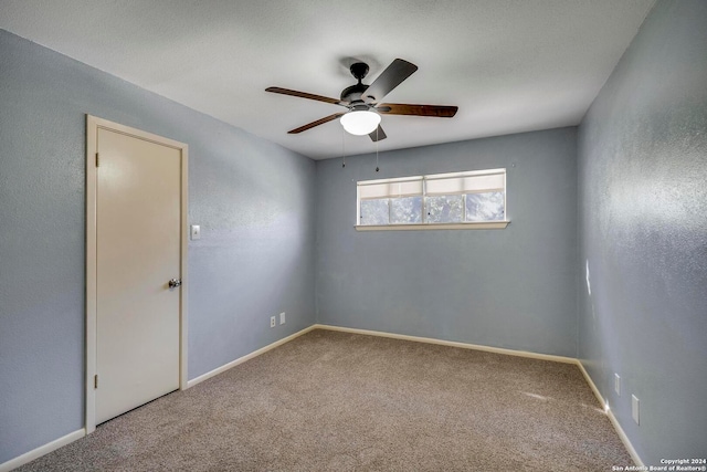 carpeted empty room with ceiling fan