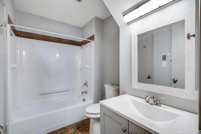 full bathroom with shower / bathing tub combination, vanity, toilet, and a textured ceiling