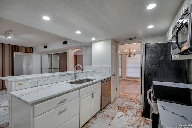 kitchen with sink, white cabinets, a textured ceiling, and appliances with stainless steel finishes