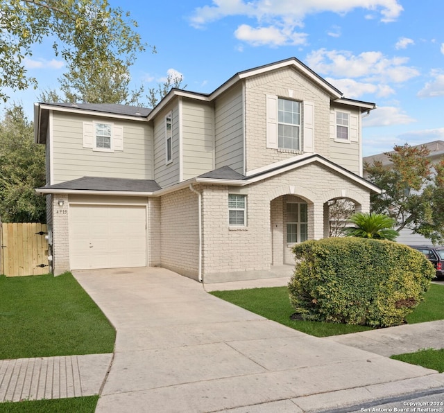 view of property featuring covered porch and a garage