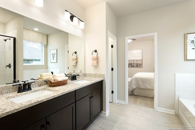 bathroom with vanity and separate shower and tub