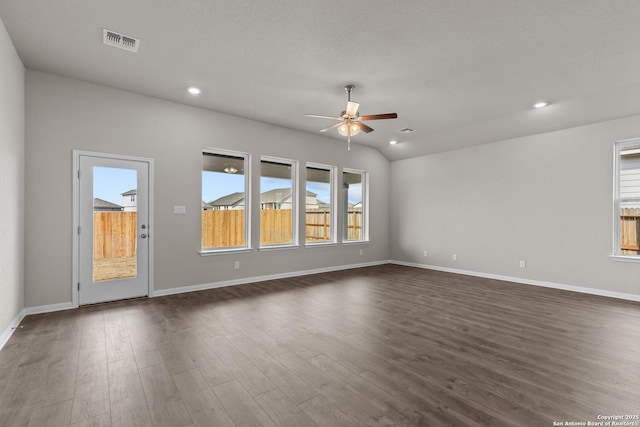 spare room featuring ceiling fan, vaulted ceiling, and dark hardwood / wood-style flooring