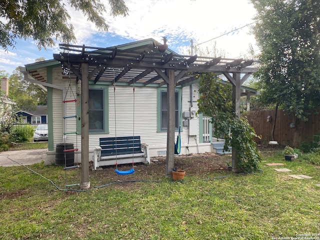 view of side of property featuring a pergola and a yard