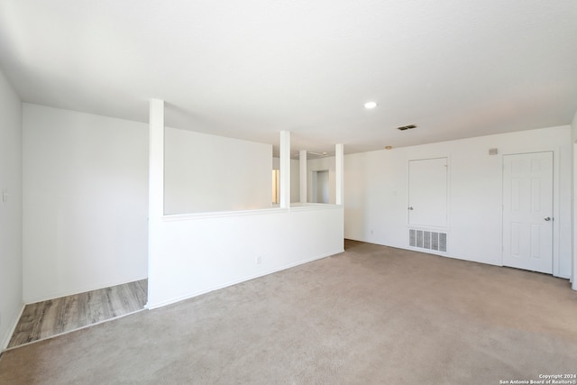 unfurnished room featuring light colored carpet