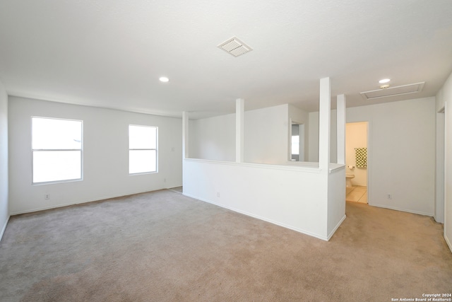 unfurnished room with light carpet