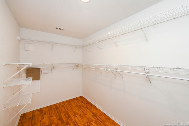 spacious closet with hardwood / wood-style flooring