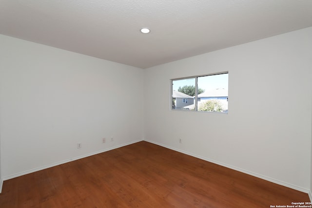 unfurnished room featuring hardwood / wood-style flooring