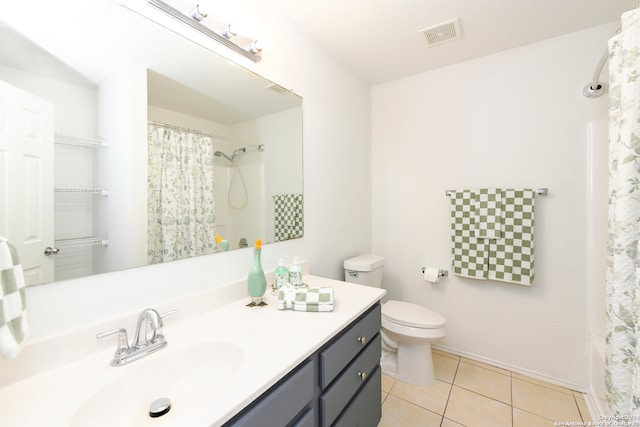 bathroom featuring tile patterned flooring, vanity, and toilet