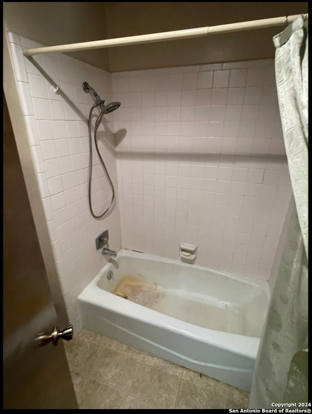 bathroom with tile patterned floors and shower / tub combo with curtain