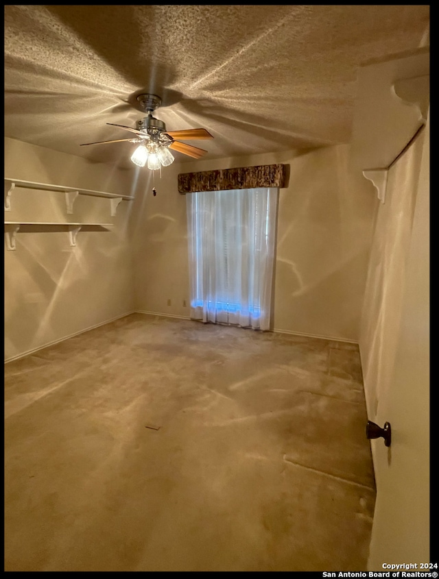 unfurnished room featuring ceiling fan and a textured ceiling