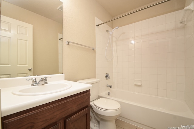 full bathroom featuring tile patterned flooring, vanity, toilet, and tiled shower / bath