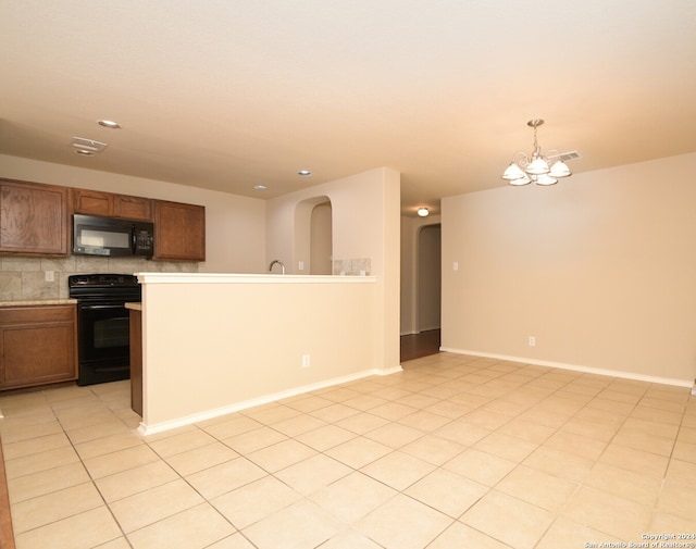 kitchen with hanging light fixtures, tasteful backsplash, a notable chandelier, light tile patterned floors, and black appliances