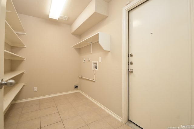 washroom with electric dryer hookup, gas dryer hookup, light tile patterned floors, and hookup for a washing machine