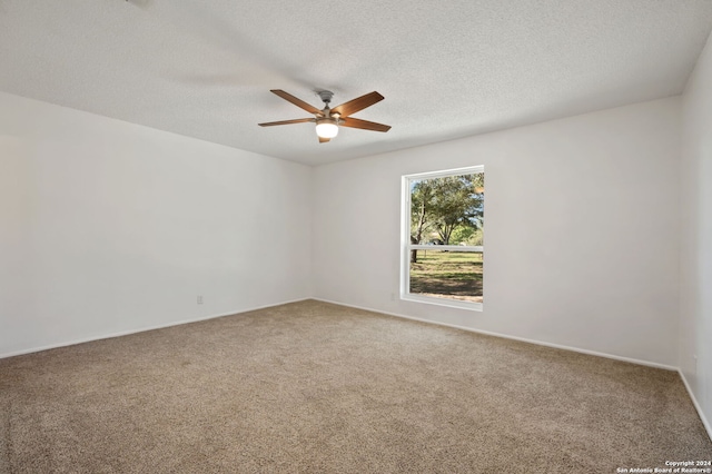 carpeted spare room with ceiling fan and a textured ceiling