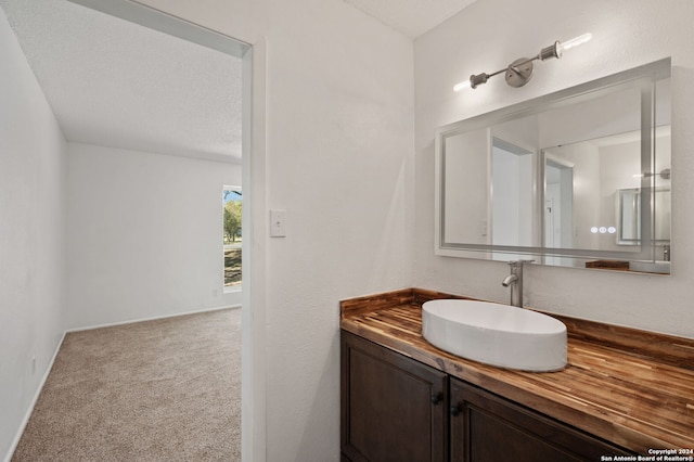 bathroom with vanity and a textured ceiling